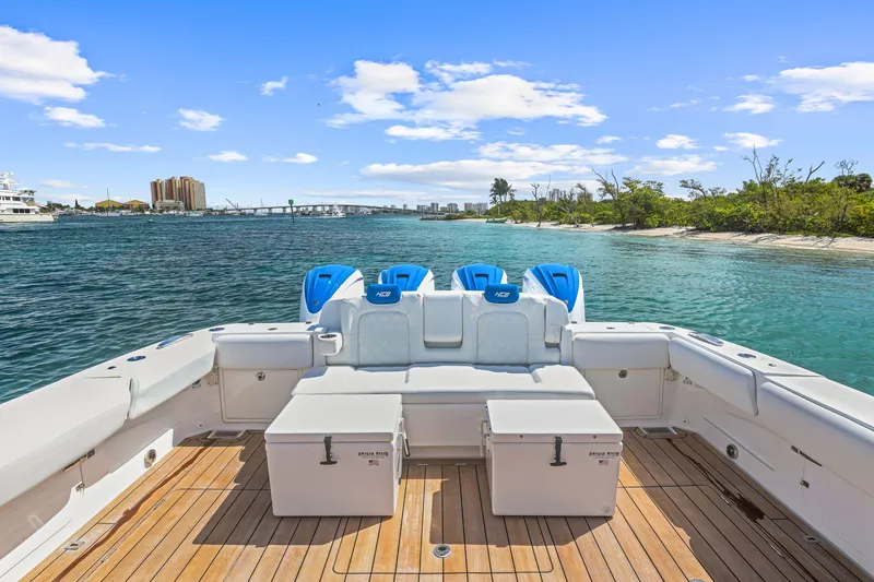 Slide: The Image of 2020 HCB 53 boat with spacious deck, scenic waterway, and clear blue sky. - 10