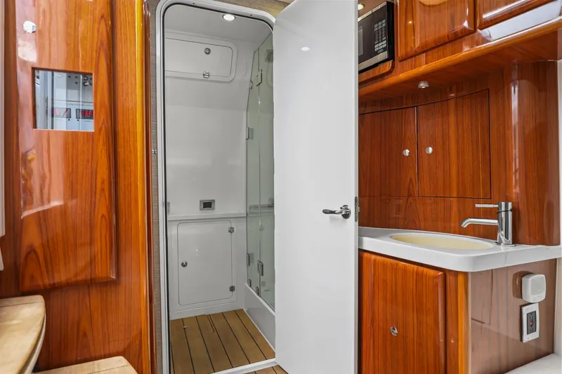 Slide: The Image of Luxurious 2020 HCB 53 yacht interior with wooden cabinetry and modern bathroom amenities. - 11