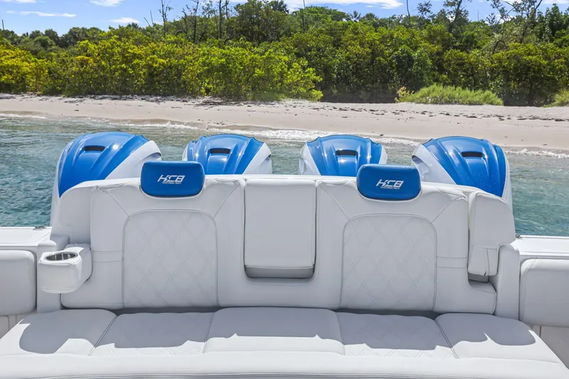 Slide: The Image of Luxury HCB 53 boat with blue engines, white seating, near a sandy beach, 2020 model. - 12