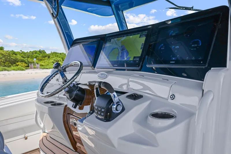 Slide: The Image of Helm of 2020 HCB 53 boat with advanced navigation displays and controls. - 13