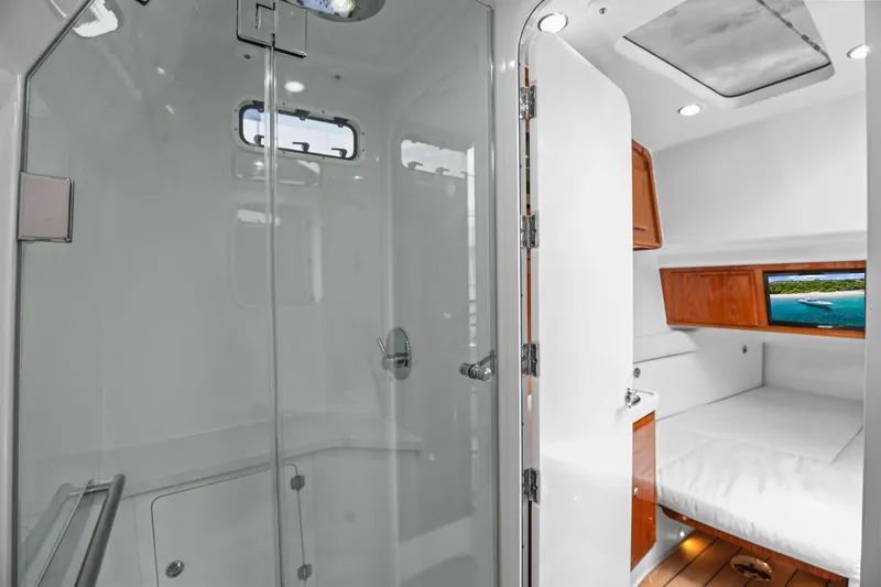 Slide: The Image of Interior of 2020 HCB 53 yacht featuring a modern bathroom and cozy cabin. - 23