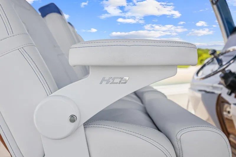 Slide: The Image of Luxury seating on 2020 HCB 53 boat with white upholstery and blue sky background. - 24