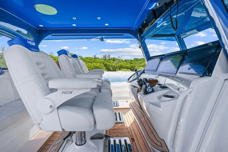 Slide: The Image of Interior of a 2020 HCB 53 boat with luxurious seating and modern dashboard. - 27