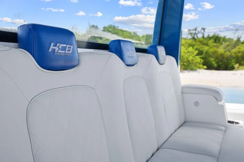 Slide: The Image of Luxurious seating in a 2020 HCB 53 boat, featuring blue headrests and white upholstery. - 29