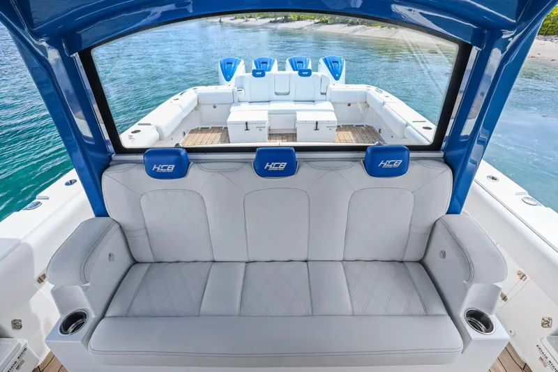 Slide: The Image of Luxury seating on a 2020 HCB 53 boat, featuring blue accents and ocean backdrop. - 30