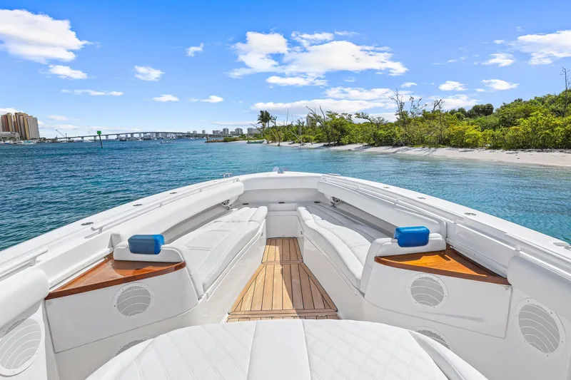 Slide: The Image of Luxurious 2020 HCB 53 boat interior with white seating, wooden accents, and scenic waterfront view. - 33