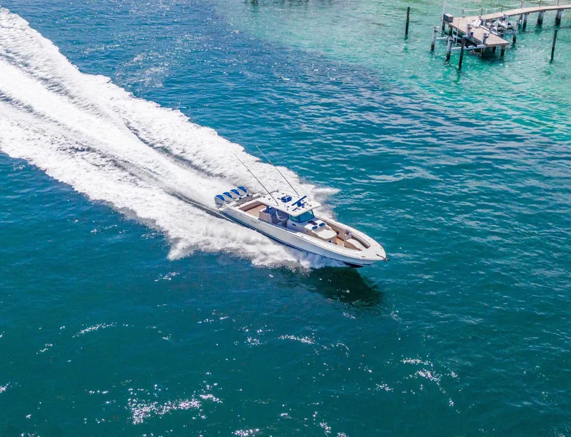 Slide: The Image of Aerial view of 2020 HCB 53 boat cruising on clear blue water. - 43