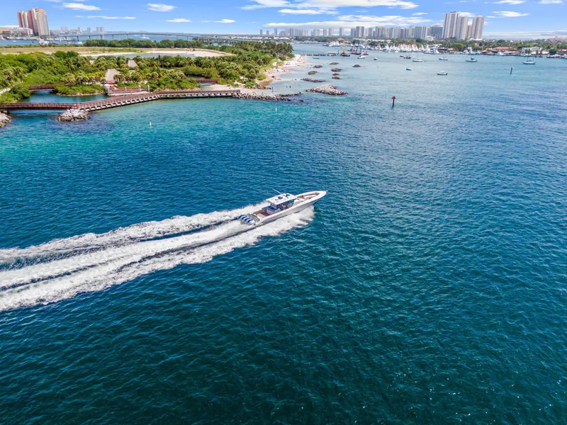 Slide: The Image of Aerial view of 2020 HCB 53 boat cruising in vibrant coastal waters. - 49