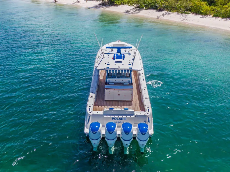 Slide: The Image of HCB 53 boat, 2020 model, cruising near a tropical beach with clear blue water. - 6