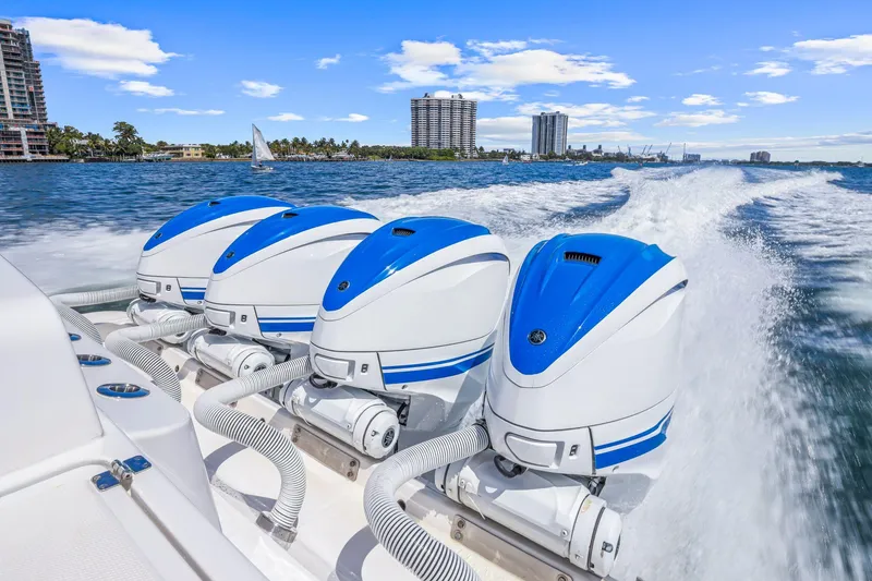 Slide: The Image of Powerful 2020 HCB 53 boat with triple outboard engines cruising on a sunny day. - 8