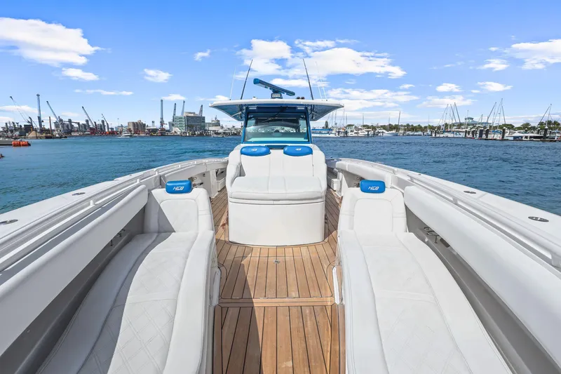 Slide: The Image of Luxury HCB 53 boat interior with white seating, wooden deck, and ocean view, 2020 model. - 9