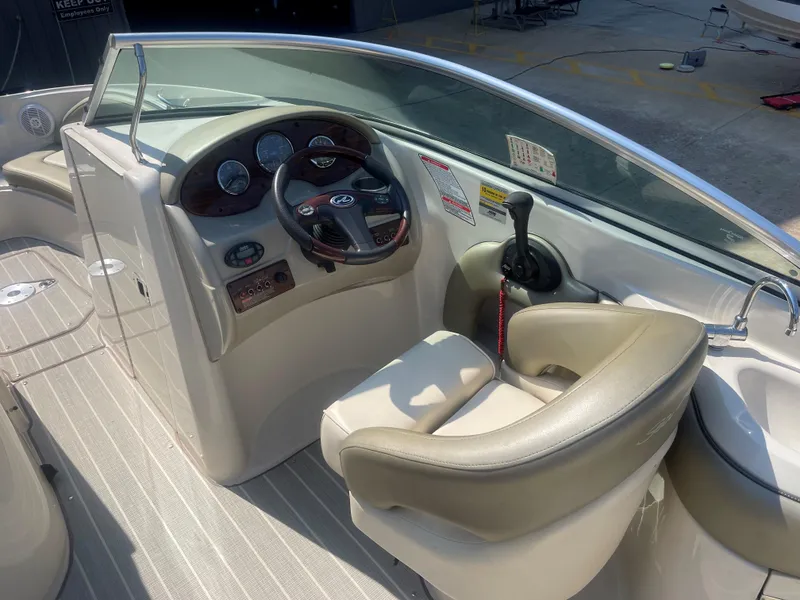 Slide: The Image of 2005 Sea Ray 220 Sundeck cockpit with steering wheel and control panel. - 3