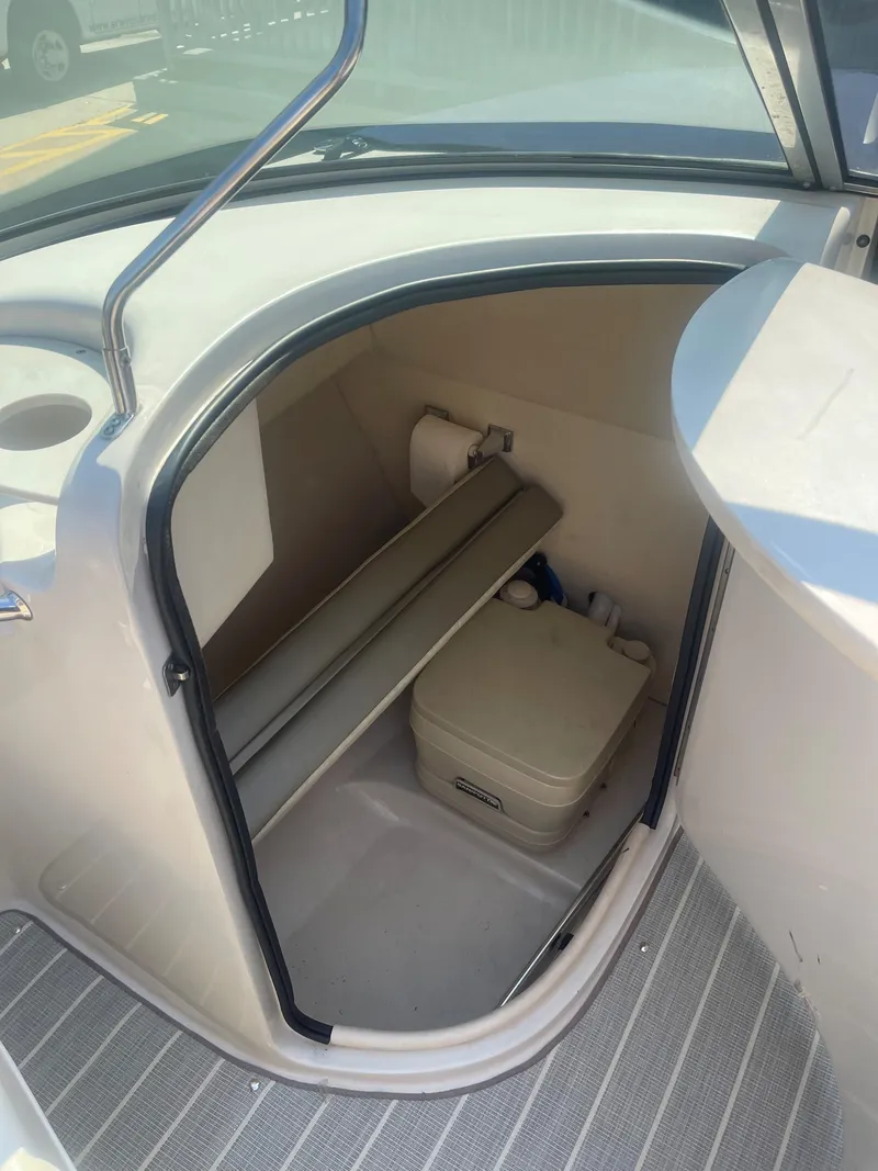 Slide: The Image of 2005 Sea Ray 220 Sundeck interior storage compartment with portable toilet. - 6