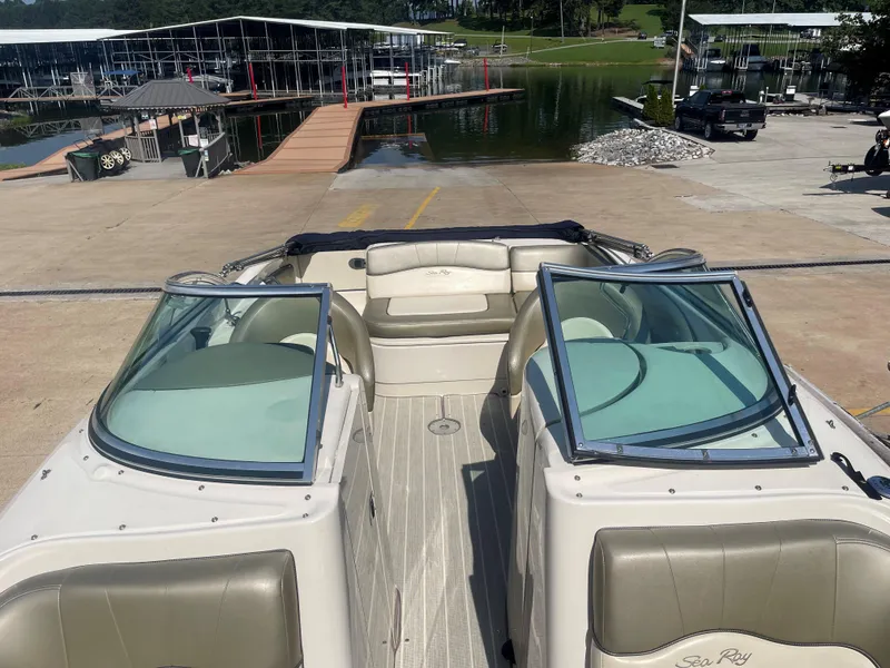 Slide: The Image of 2005 Sea Ray 220 Sundeck boat docked at marina with open seating area. - 7