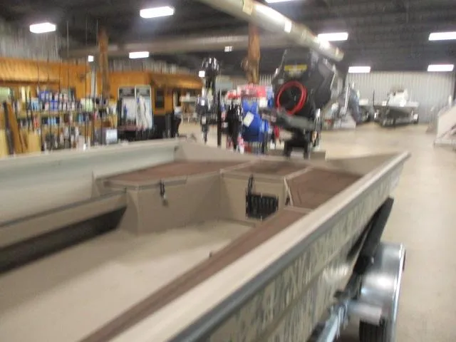 Slide: The Image of 2025 Reaper Boats 656-MUD BOAT displayed in a showroom with motor and equipment. - 10