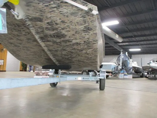 Slide: The Image of 2025 Reaper Boats 656-MUD BOAT on trailer in showroom, showcasing camo design. - 4