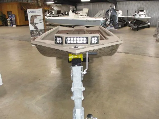 Slide: The Image of 2025 Reaper Boats 656-MUD BOAT displayed in showroom, front view with LED lights. - 5