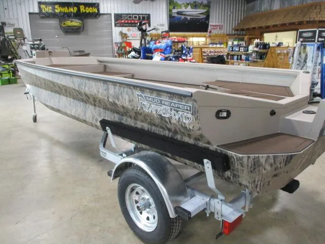 Slide: The Image of 2025 Reaper Boats 656-MUD, camo design, displayed indoors on a trailer. - 6