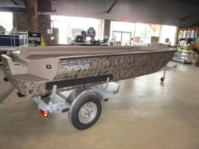 Slide: The Image of 2025 Reaper Boats 656-MUD, camo design, on trailer in showroom. - 8