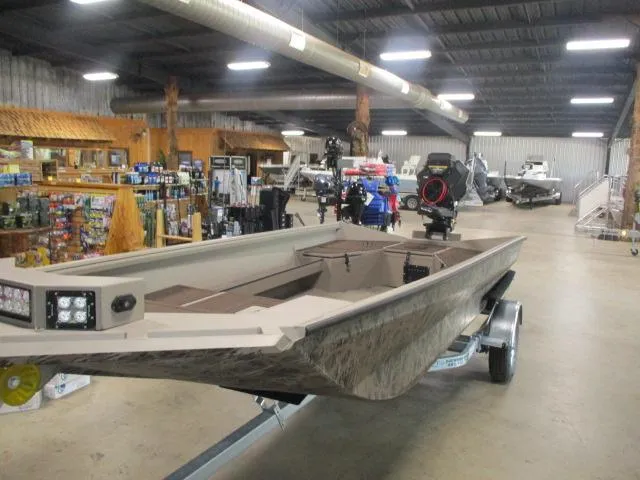 Slide: The Image of 2025 Reaper Boats 656-MUD BOAT displayed in a showroom with various marine equipment. - 9