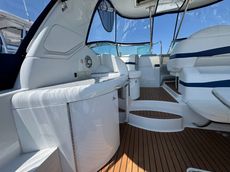 Slide: The Image of 2008 Formula 40 PC yacht interior with sleek white seating and wooden flooring. - 11