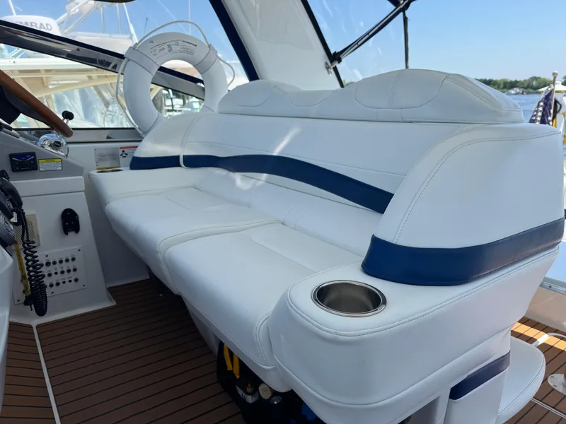 Slide: The Image of 2008 Formula 40 PC yacht interior with white and blue seating, cup holder, and wooden flooring. - 17