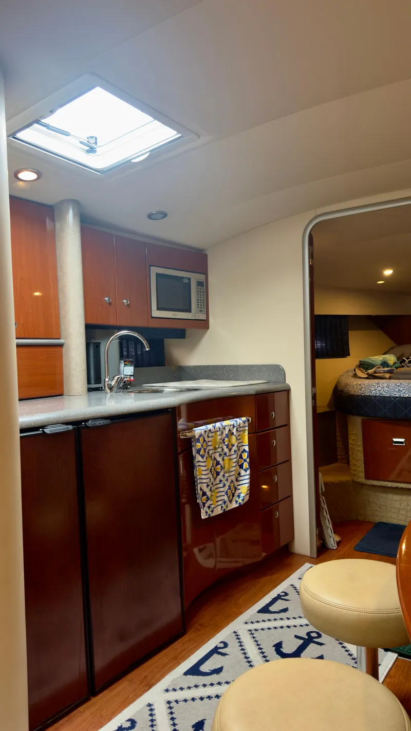 Slide: The Image of 2008 Formula 40 PC yacht interior with kitchen, seating, and bedroom. - 29
