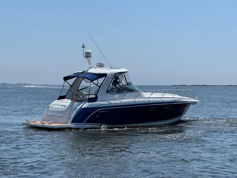 Slide: The Image of 2008 Formula 40 PC yacht cruising on open water under clear skies. - 4