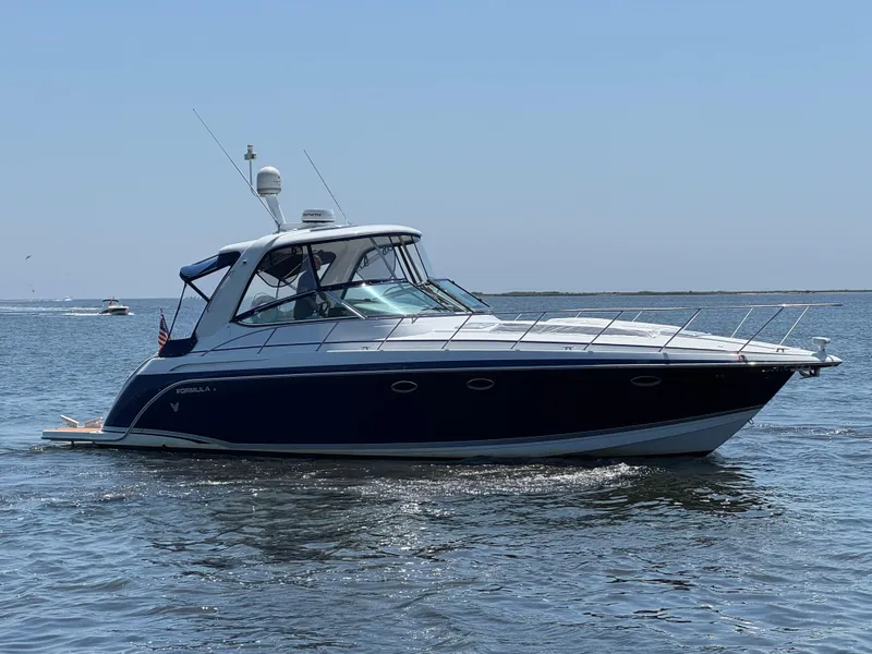 Slide: The Image of 2008 Formula 40 PC yacht cruising on open water under clear blue sky. - 5