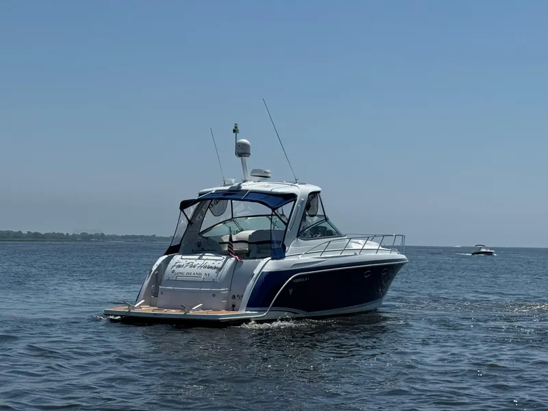 Slide: The Image of 2008 Formula 40 PC yacht cruising on open water under clear blue sky. - 6