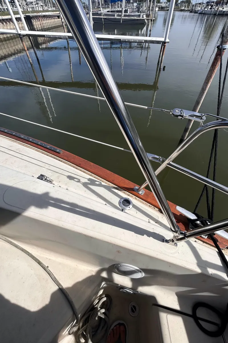 Slide: The Image of 1982 S2 11.0 A sailboat deck with marina view and stainless steel rigging. - 13