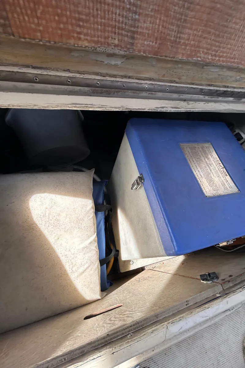 Slide: The Image of Storage compartment with blue box and various items in 1982 S2 11.0 A model. - 14