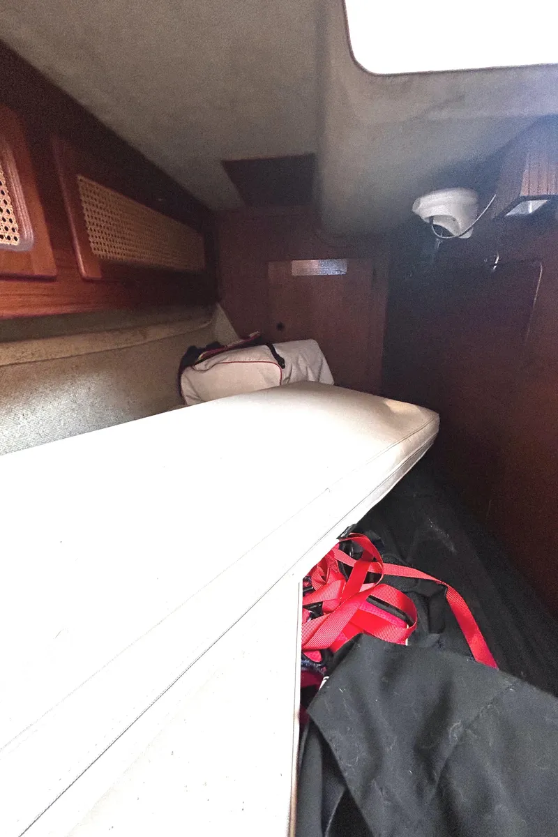 Slide: The Image of Interior cabin of 1982 S2 11.0 A sailboat with storage and cushions. - 16