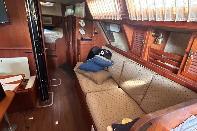 Slide: The Image of Interior of a 1982 S2 11.0 A sailboat with cozy seating and wooden accents. - 18