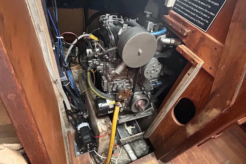 Slide: The Image of Engine compartment of a 1982 S2 11.0 A sailboat, showcasing mechanical components and wiring. - 20