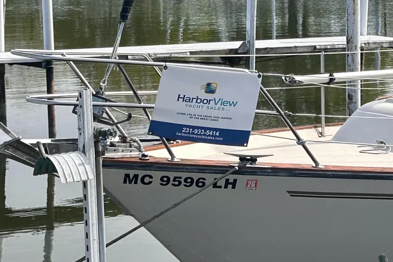 Slide: The Image of S2 11.0 A 1982 sailboat with HarborView Yacht Sales sign at dock. - 4