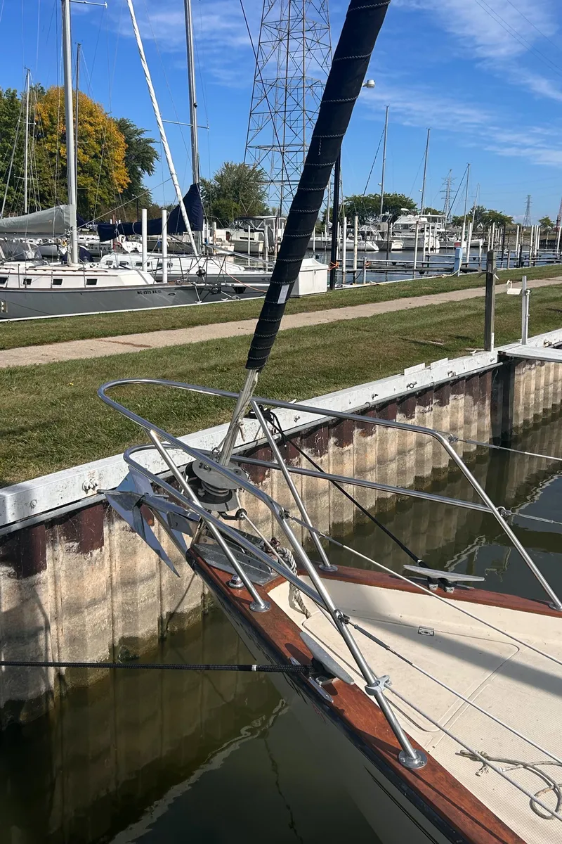 Slide: The Image of 1982 S2 11.0 A sailboat docked in a marina with clear blue skies. - 5