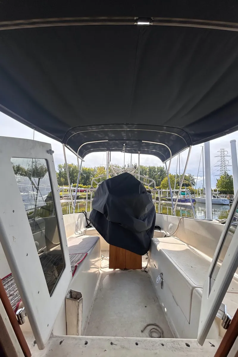 Slide: The Image of 1982 S2 11.0 A sailboat interior with covered helm and canopy. - 8