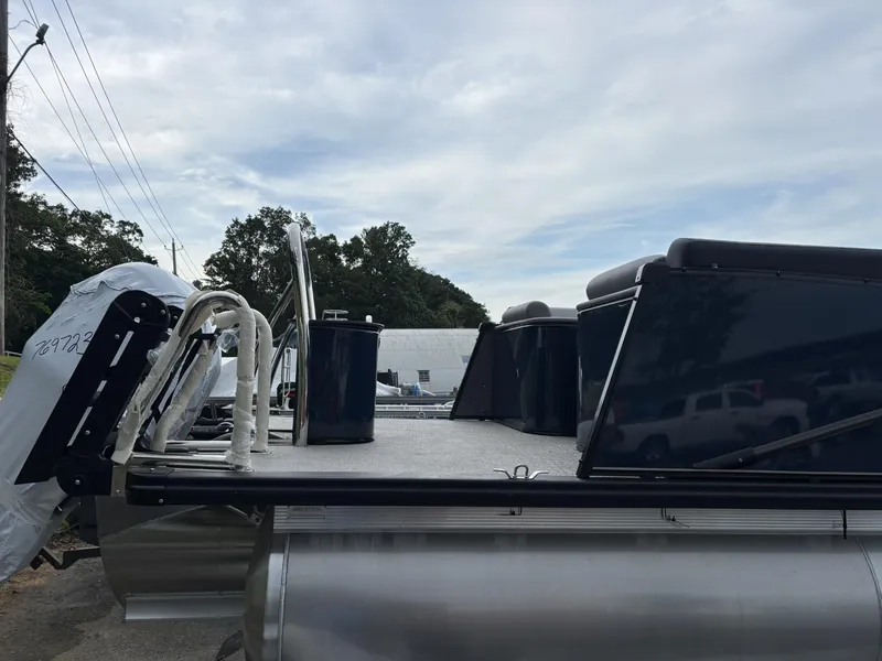 Slide: The Image of 2025 Avalon Catalina Quad Lounger Windshield pontoon boat, side view, parked outdoors. - 4