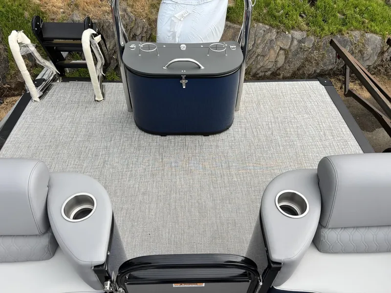 Slide: The Image of 2025 Avalon Catalina Quad Lounger Windshield boat interior with seating and cup holders. - 9