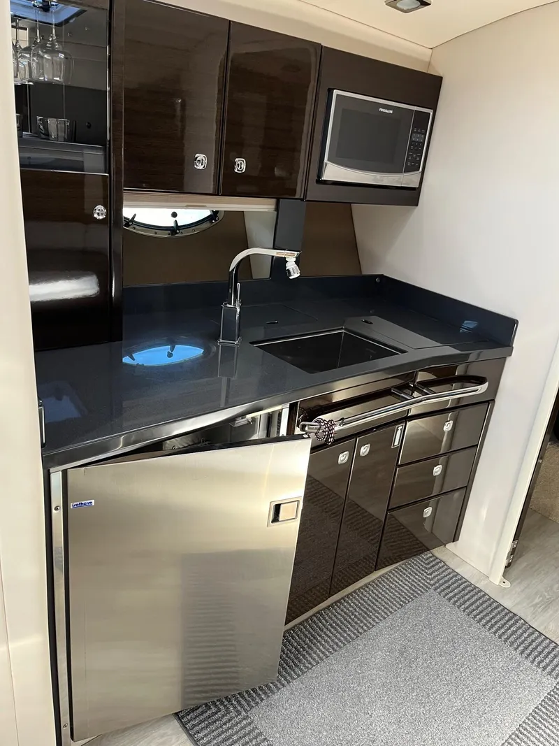 Slide: The Image of Modern kitchen in 2016 Formula 37 PC yacht with sleek cabinetry and stainless steel appliances. - 14