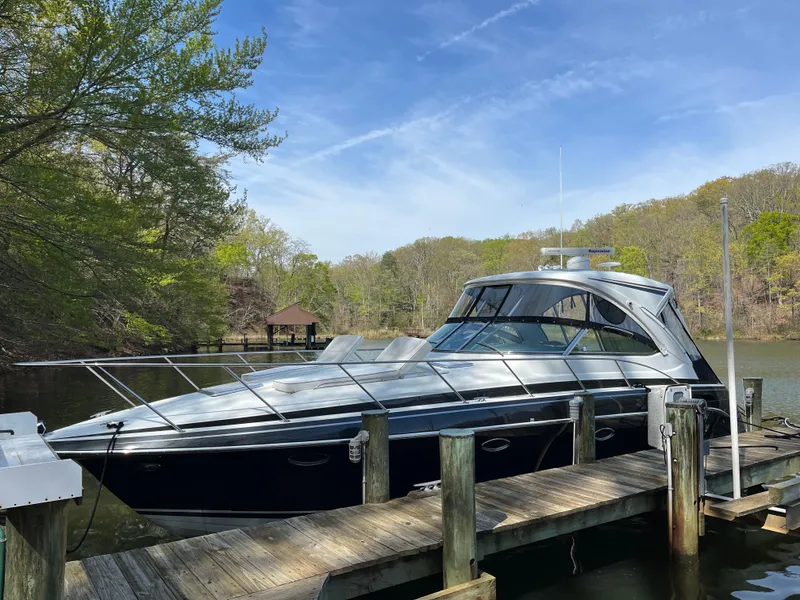 Slide: The Image of 2016 Formula 37 PC yacht docked by a scenic lakeside with lush greenery. - 3