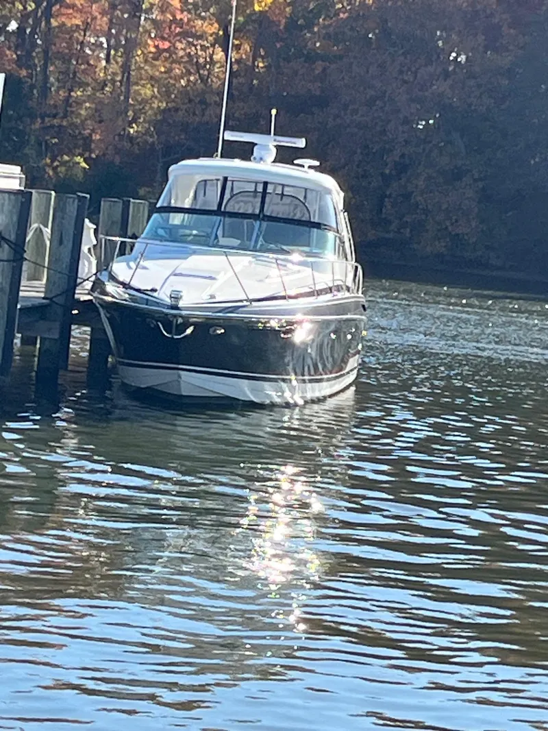 Slide: The Image of 2016 Formula 37 PC yacht docked on a sunny day, reflecting on the water. - 4