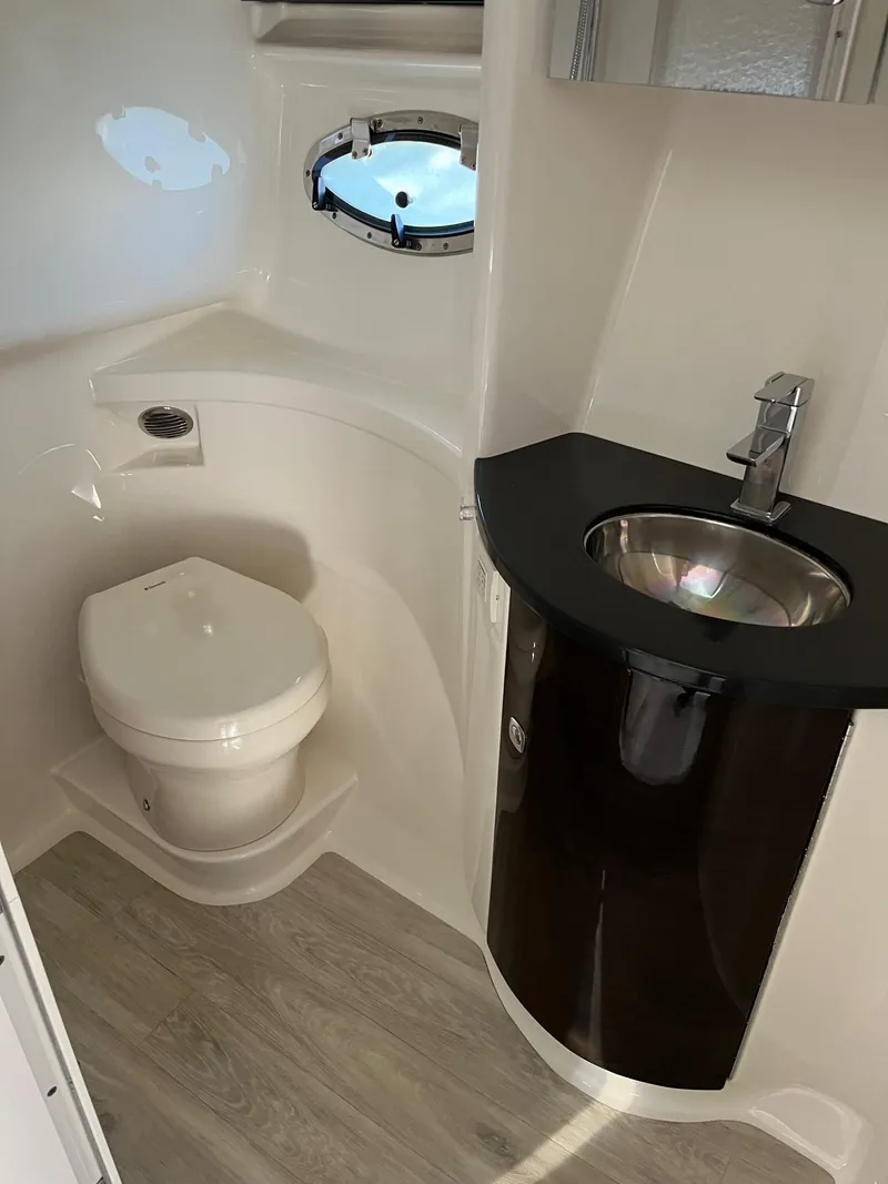 Slide: The Image of 2016 Formula 37 PC yacht bathroom with toilet, sink, and porthole window. - 9