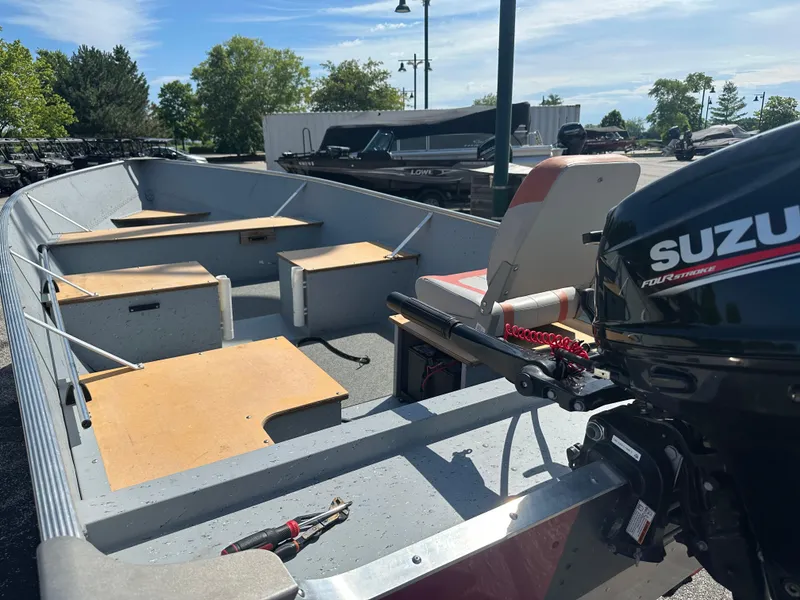 Slide: The Image of 2021 Lund SSV-16 boat with Suzuki outboard motor, featuring spacious interior and seating. - 2