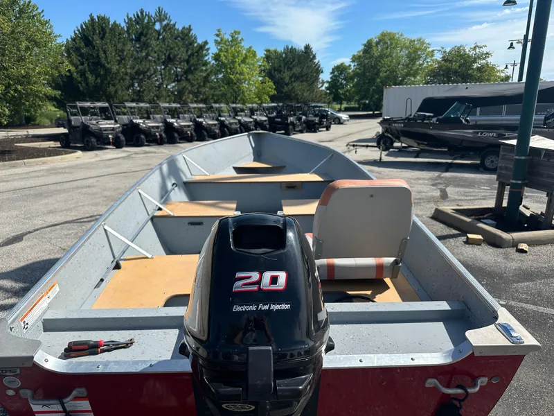 Slide: The Image of 2021 Lund SSV-16 boat with outboard motor in a parking lot. - 4