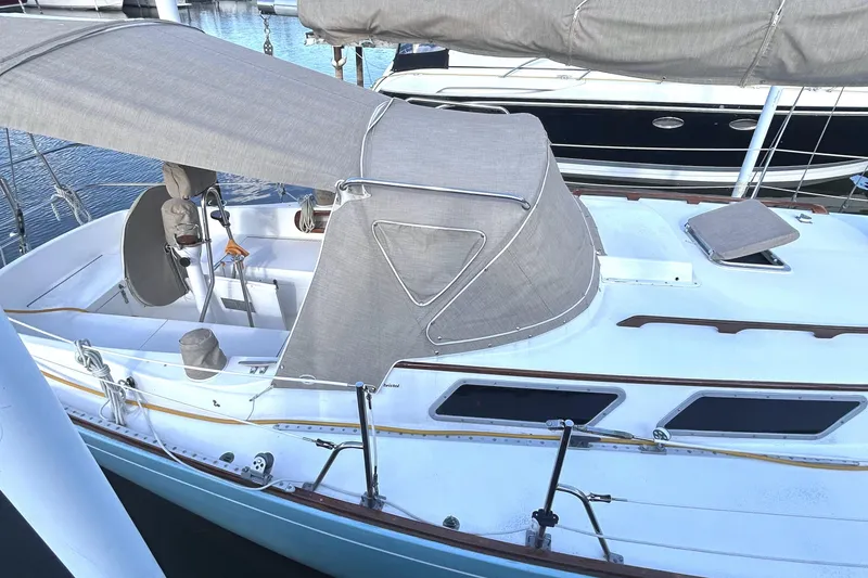 Slide: The Image of 1980 Bristol 35.5 sailboat with gray canvas cover, docked at marina. - 1