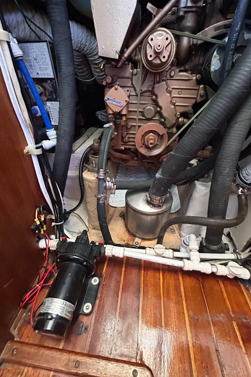 Slide: The Image of Engine compartment of a 1980 Bristol 35.5 sailboat, showcasing mechanical components and wiring. - 14
