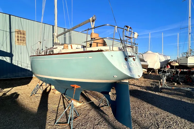 Slide: The Image of 1980 Bristol 35.5 sailboat on stands in a boatyard under clear blue sky. - 15