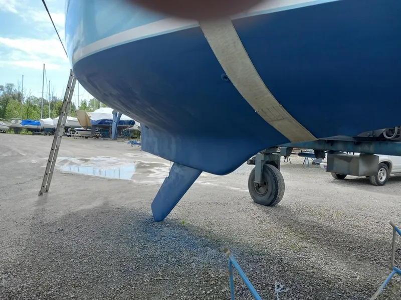 Slide: The Image of 1980 Bristol 35.5 sailboat on trailer, showing keel and hull in a boatyard. - 16